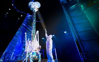 A BAE Systems engineer examines NASA’s Imaging X-ray Polarimetry Explorer (IXPE) spacecraft.