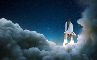 Rocket blasts past the clouds into space.