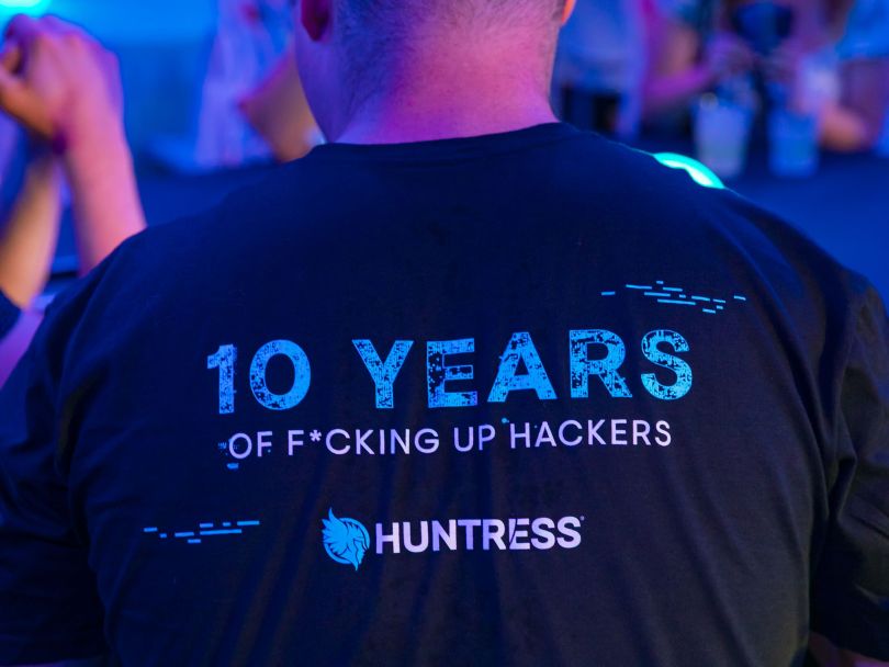 A Huntress team member wears a branded T-shirt commemorating the company’s tenth anniversary