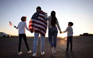 A family walking toward the horizon holding hands and U.S. flags are shown.