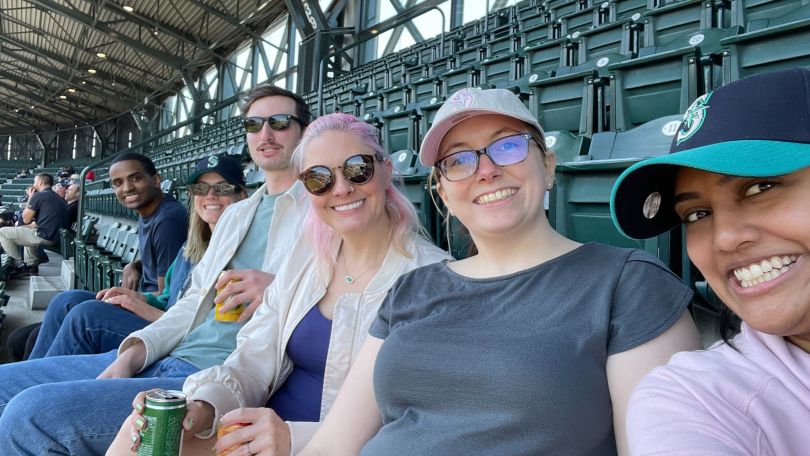 A group of Qualtrics employees at a sporting event.
