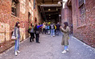 Seattle, Washington, United States - 04-29-2019: A view of several people taking photos with the infamous Gum Wall